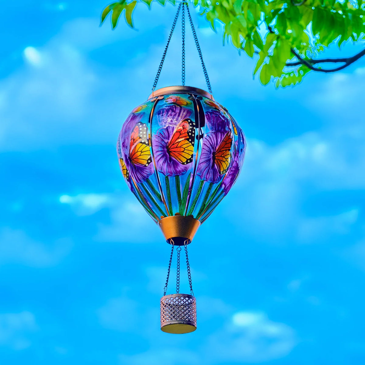 Butterfly balloon solar lantern illuminating a flowerbed, perfect for backyard lights and garden solar decor